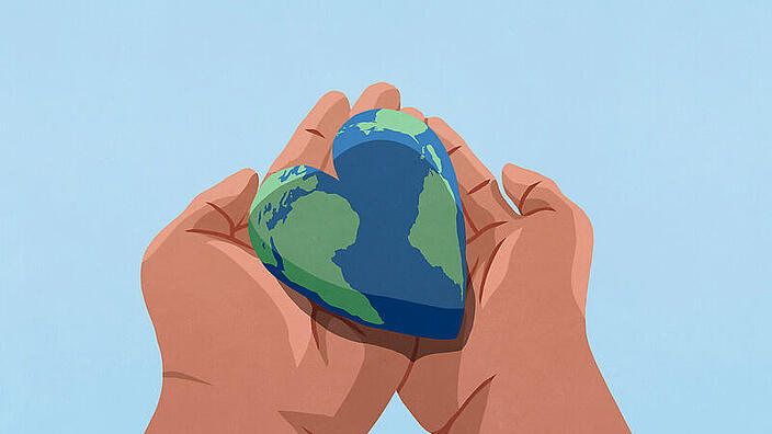 Hände die die Erde in Form eines Herzens halten